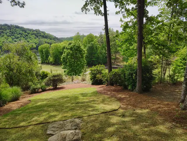 Landscaped front yard around a stone house in Asheville, NC