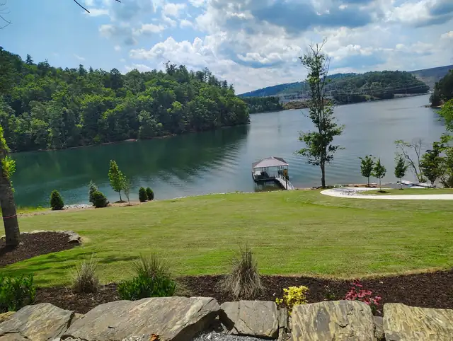 Manicured lakefront lawn maintained by Ruben's Landscaping near Asheville NC
