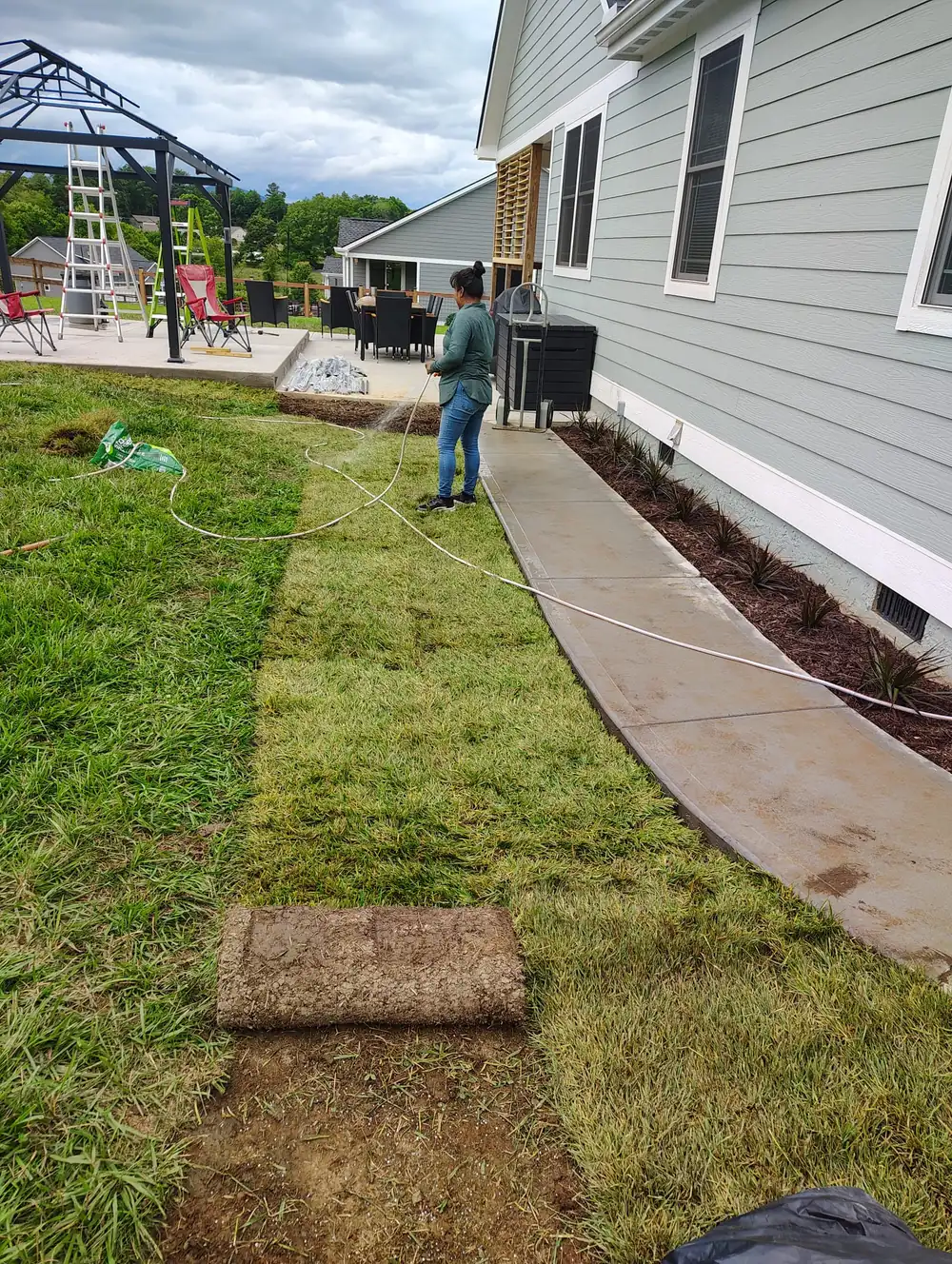 New sod being watered in after installation in Asheville, NC